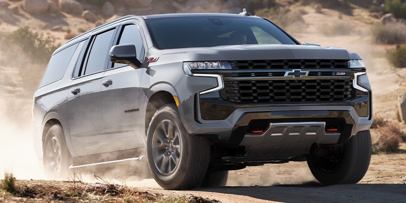 A Chevrolet Suburban stands prominently, showcasing its bold and dynamic front view