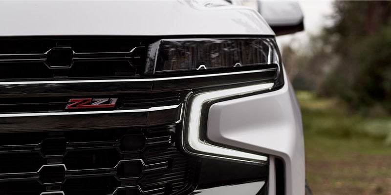 A Chevrolet Suburban stands prominently, showcasing its bold and dynamic front view