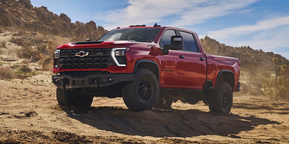 Silverado 2500 HD stands parked on open ground, showcasing its rugged design and robust presence